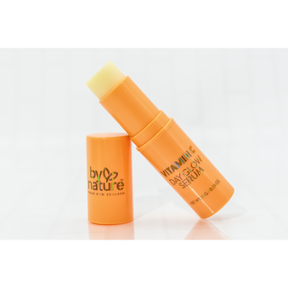 Two orange skincare serum bottles with a white background