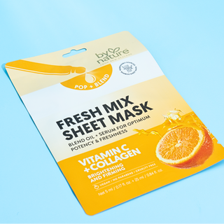 Fresh mix sheet mask packaging with orange slices on a blue background